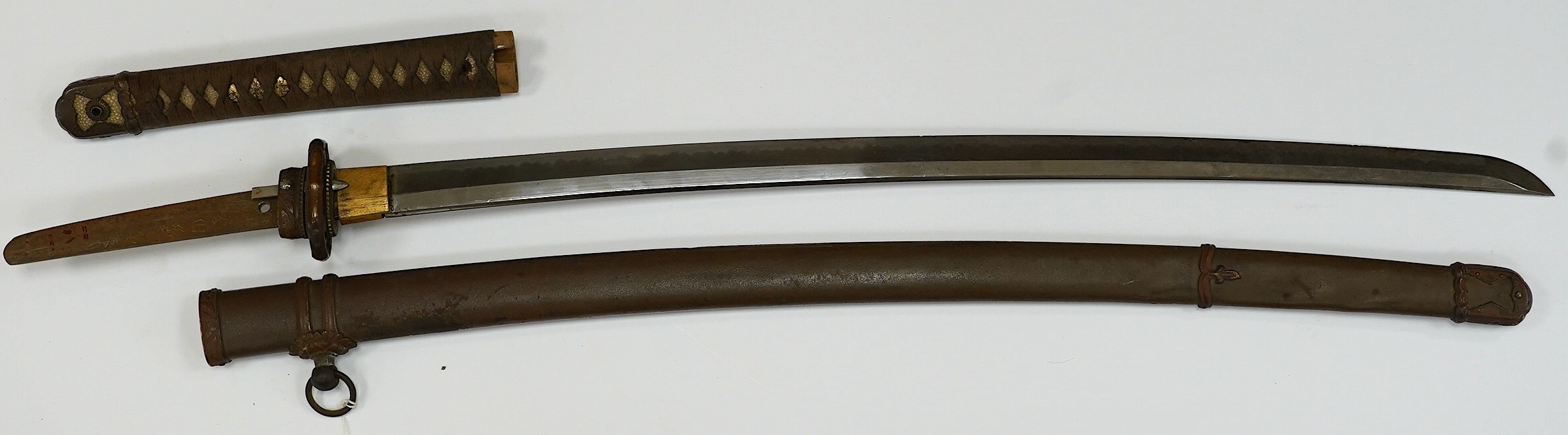 A Japanese WWII army officer’s sword Katana, blade 65cm, signed tang, retaining good polish, in shin gunto mounts. Condition - good
